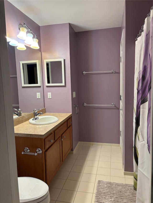 bathroom featuring vanity, tile patterned floors, and toilet