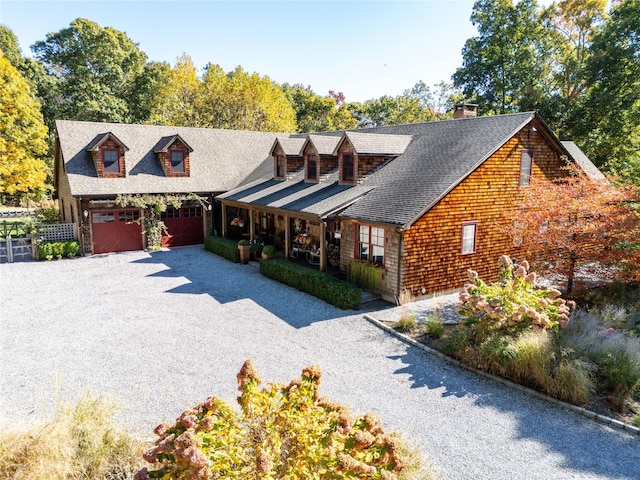 view of front of home featuring a garage and a porch