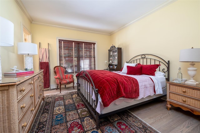 bedroom with crown molding and dark hardwood / wood-style floors