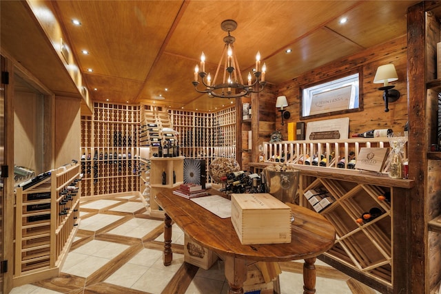 wine area featuring wooden ceiling, a chandelier, and wood walls