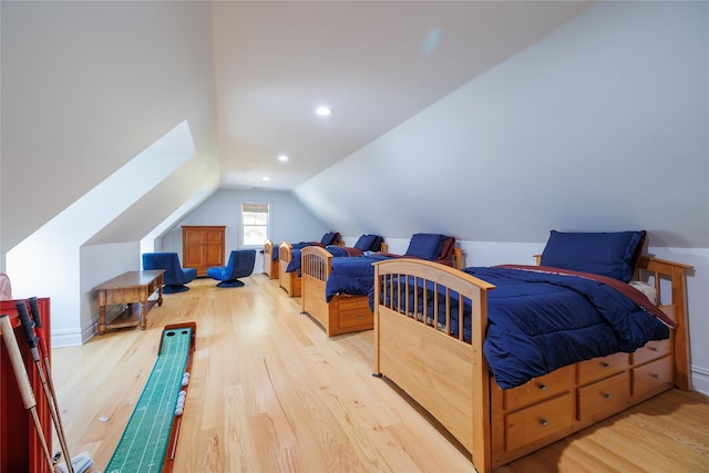 bedroom featuring vaulted ceiling and light hardwood / wood-style flooring