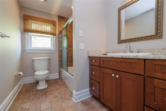 full bathroom featuring toilet, vanity, and shower / bath combination with glass door