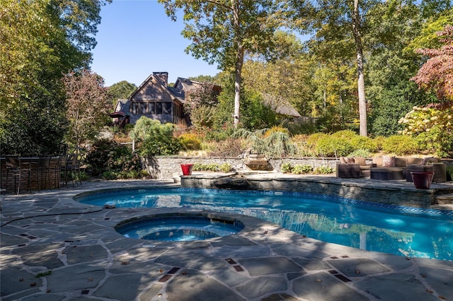 view of pool featuring outdoor lounge area and an in ground hot tub