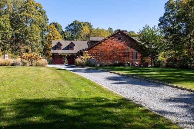 view of front of property with a garage and a front lawn