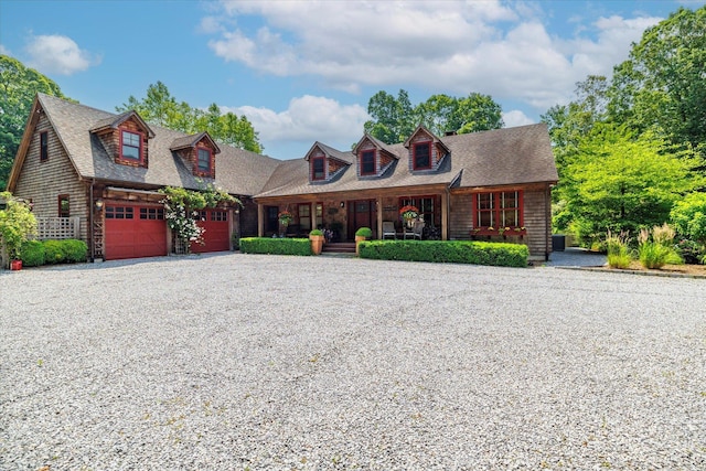 1750 Laurel Lake Dr, Mattituck, NY 11952 - view of front of home with covered porch, driveway, a garage, and roof with shingles