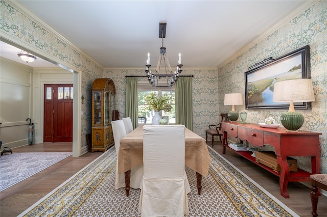1750 Laurel Lake Dr, Mattituck, NY 11952 - dining area with a chandelier, wallpapered walls, wood finished floors, and ornamental molding