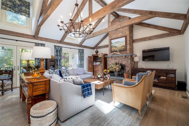 1750 Laurel Lake Dr, Mattituck, NY 11952 - living area with french doors, a fireplace, high vaulted ceiling, beamed ceiling, and wood finished floors