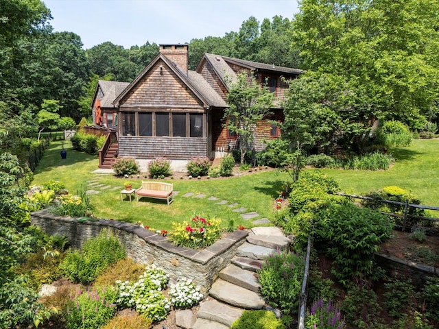 1750 Laurel Lake Dr, Mattituck, NY 11952 - view of front of house with stairway, a chimney, and a sunroom