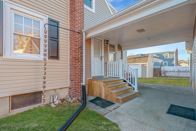 property entrance with a lawn