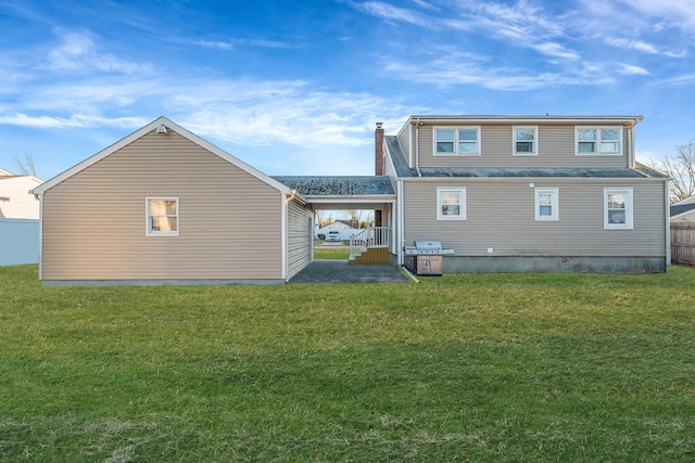 rear view of property with a yard