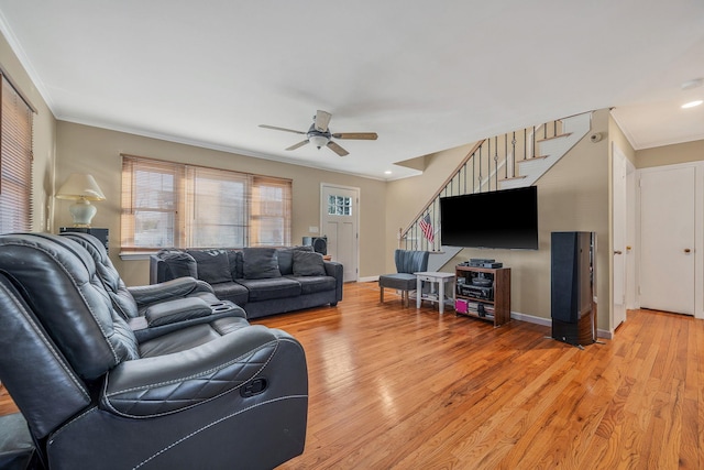 living room featuring crown molding, light hardwood / wood-style flooring, and ceiling fan