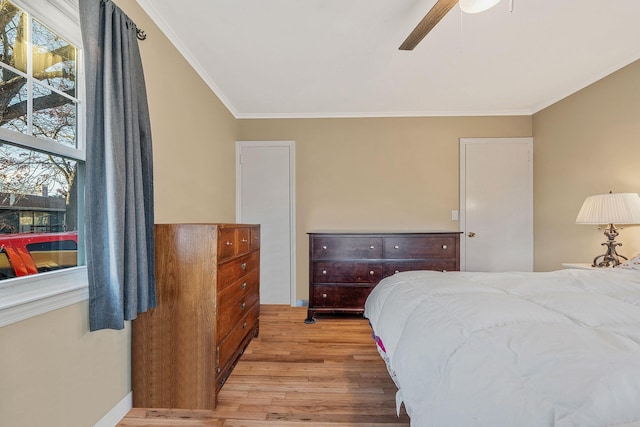 bedroom featuring multiple windows, crown molding, light hardwood / wood-style flooring, and ceiling fan