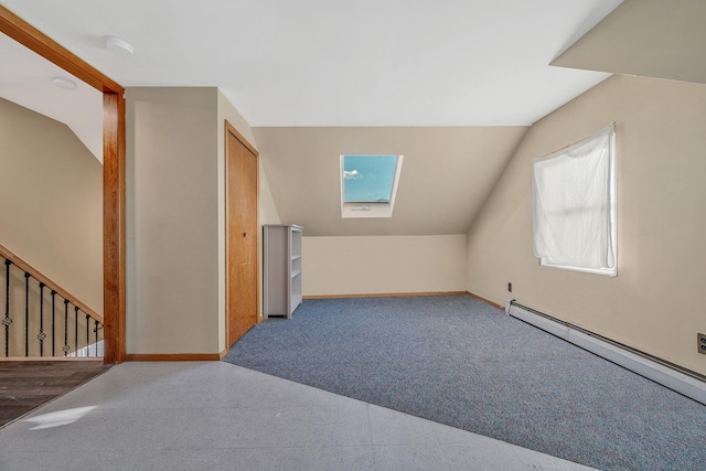 additional living space with lofted ceiling with skylight, carpet flooring, and baseboard heating