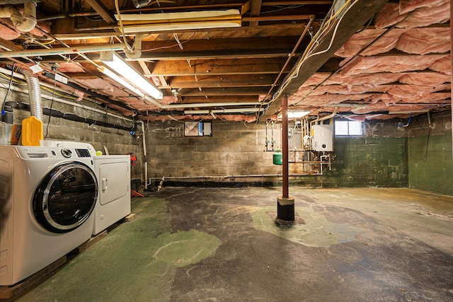 basement with water heater and washer and clothes dryer