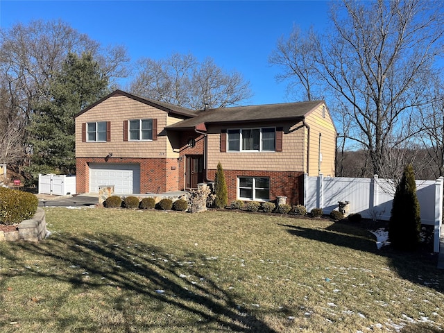 view of front of home with a garage and a front lawn