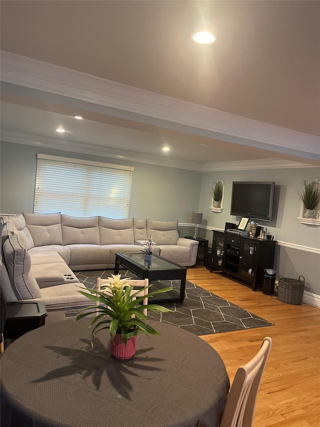 living room with crown molding and hardwood / wood-style floors