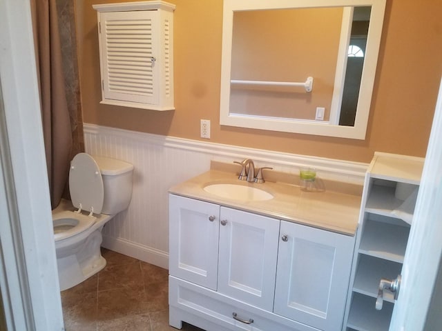 bathroom featuring tile patterned flooring, vanity, and toilet