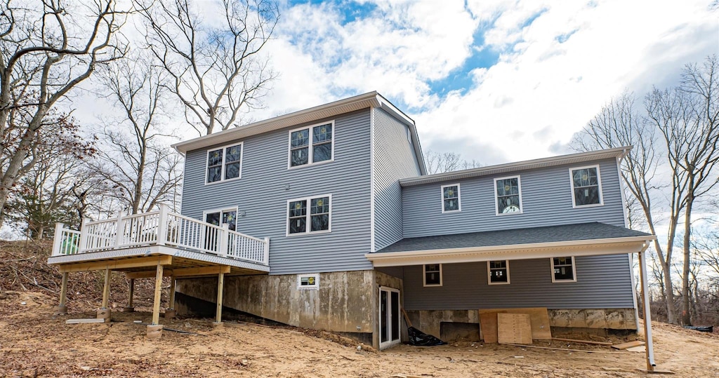 rear view of house with a wooden deck