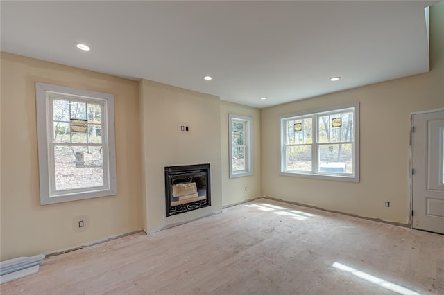 597 Pulaski, Kings Park, NY 11754 - unfurnished living room with a glass covered fireplace and recessed lighting