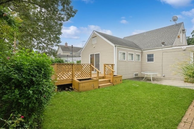 back of property with a wooden deck and a yard