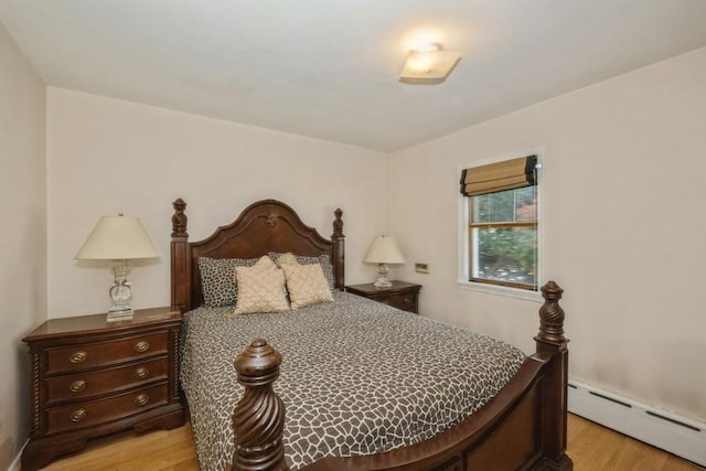 bedroom featuring light hardwood / wood-style flooring and a baseboard radiator