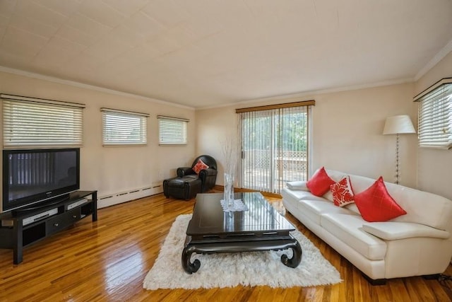 living room with baseboard heating, crown molding, and hardwood / wood-style flooring