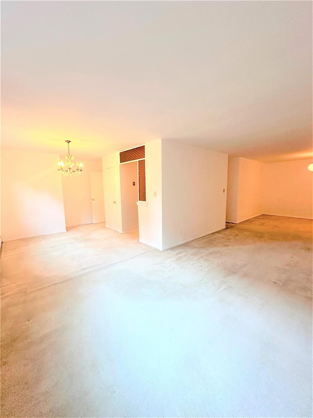 unfurnished room featuring an inviting chandelier and concrete floors