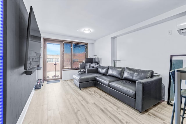 living room featuring a wall mounted AC and light wood-type flooring