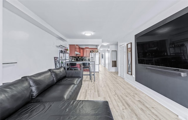 living room with light hardwood / wood-style floors and a wall mounted AC