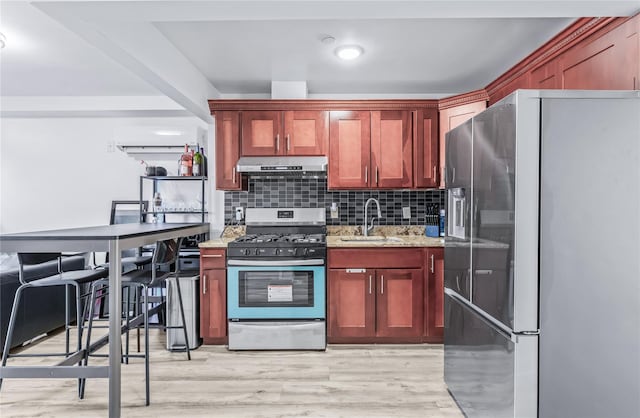 kitchen featuring extractor fan, sink, decorative backsplash, stainless steel appliances, and light wood-type flooring