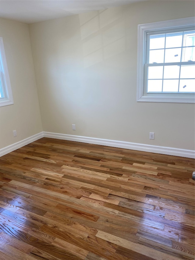 unfurnished room with hardwood / wood-style flooring