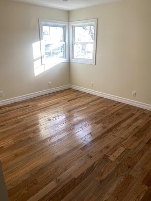 empty room with dark hardwood / wood-style floors