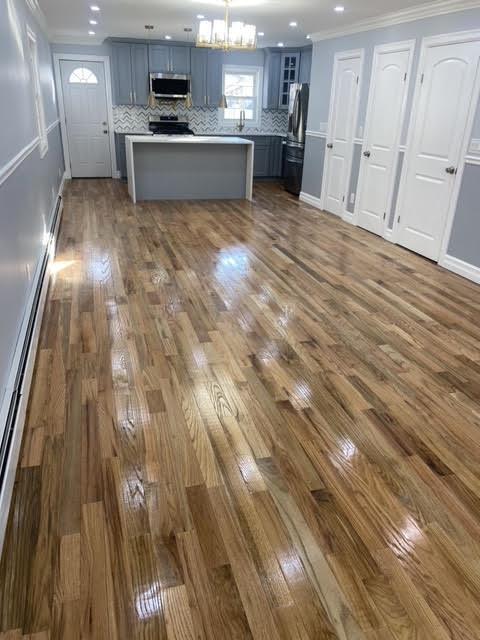 kitchen with ornamental molding, stainless steel appliances, and dark hardwood / wood-style floors