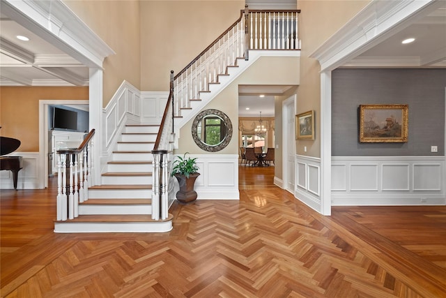 foyer entrance with parquet floors and a notable chandelier