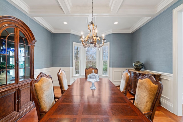 dining room with beamed ceiling, coffered ceiling, a notable chandelier, and light hardwood / wood-style floors