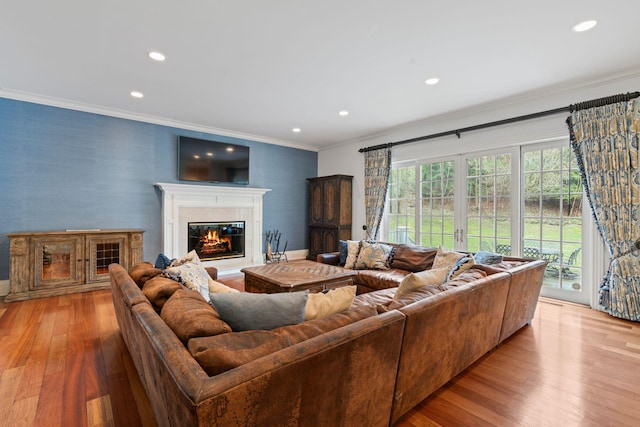 living room featuring crown molding and light hardwood / wood-style floors