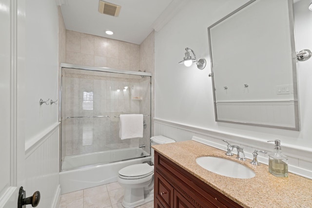 full bathroom with tile patterned flooring, vanity, combined bath / shower with glass door, and toilet