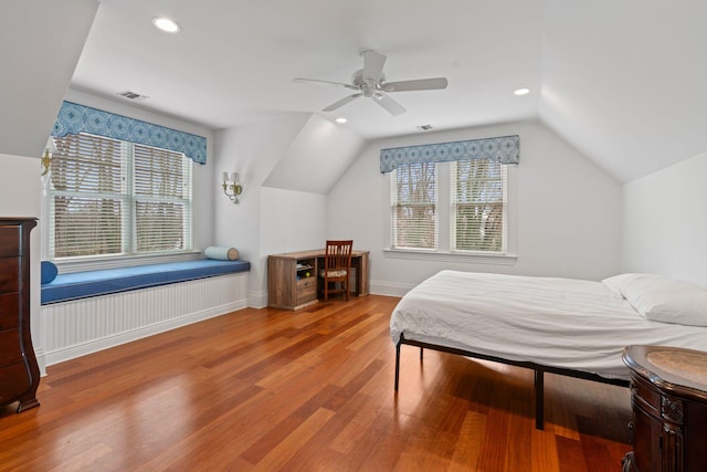 bedroom featuring hardwood / wood-style floors, vaulted ceiling, and ceiling fan