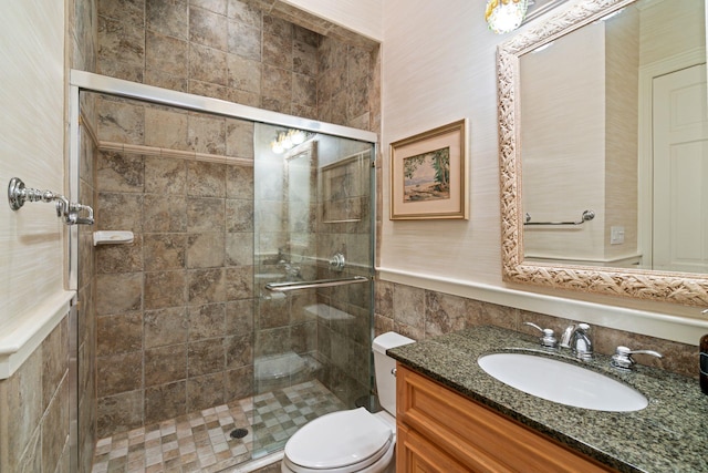 bathroom with vanity, toilet, and walk in shower