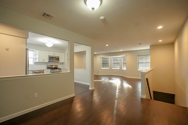 unfurnished living room featuring dark hardwood / wood-style floors