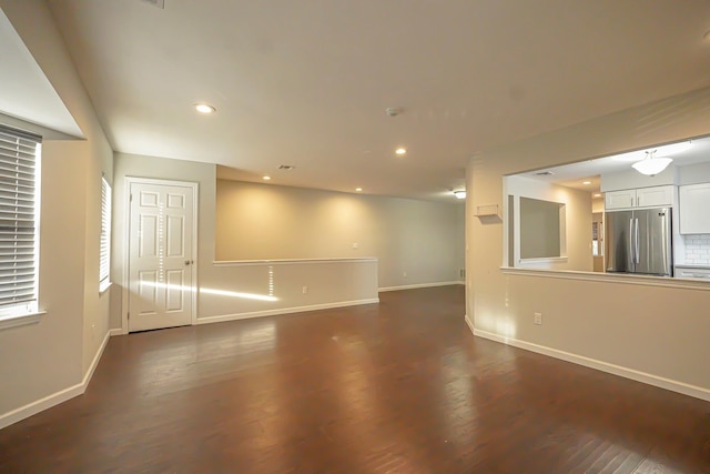 spare room with dark wood-type flooring