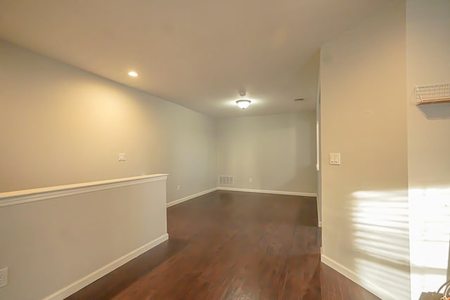 spare room featuring dark hardwood / wood-style flooring