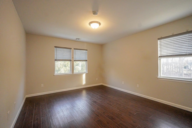 empty room with dark hardwood / wood-style floors