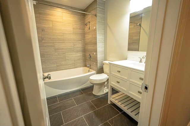 full bathroom featuring vanity, tiled shower / bath combo, tile patterned floors, and toilet