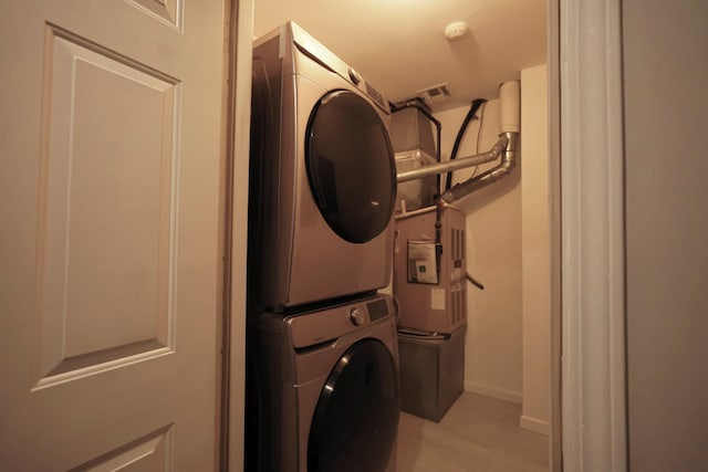 laundry area with stacked washing maching and dryer