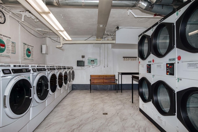 washroom featuring stacked washer and dryer and washing machine and clothes dryer