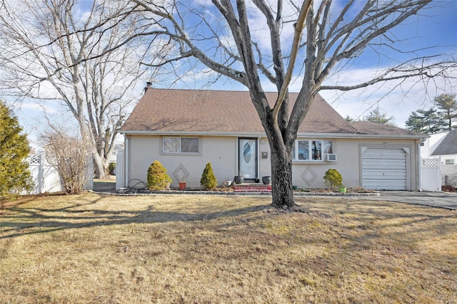 view of front of property featuring a garage and a front yard