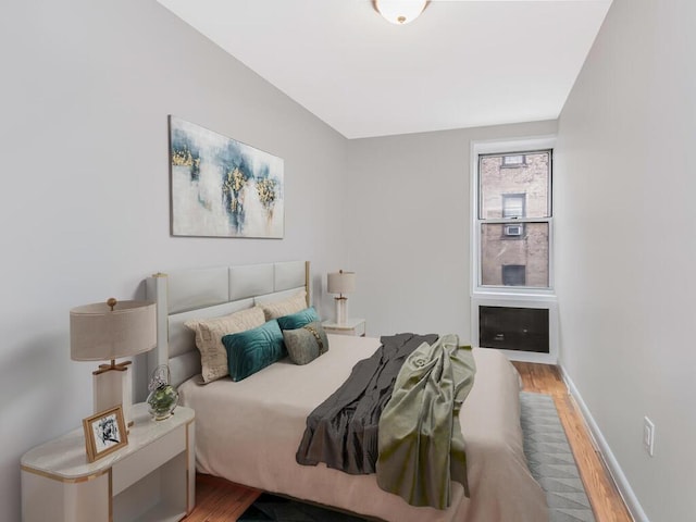 bedroom with wood finished floors and baseboards