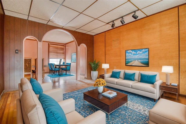 living room featuring wood-type flooring and wooden walls