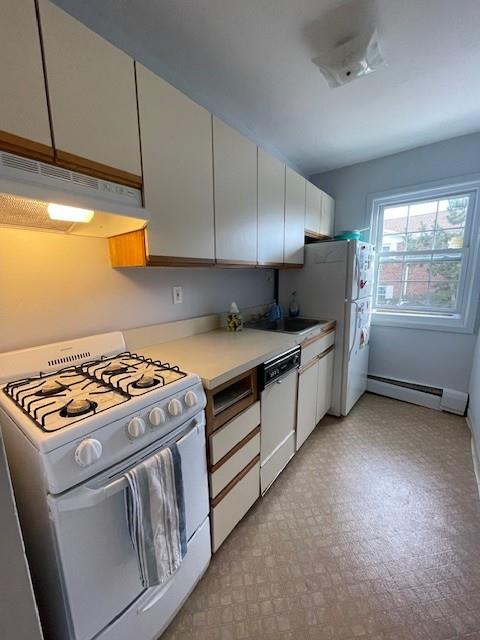 kitchen with white cabinetry, a baseboard heating unit, sink, and white appliances